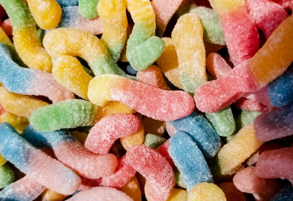 Some colorful gummy worms coated in sugar
