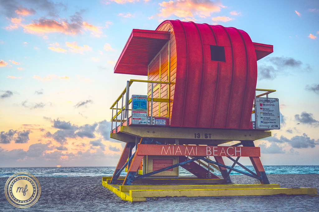 A lifeguard tower on the beach at sunset. The Mellow Fellow logo in foreground.