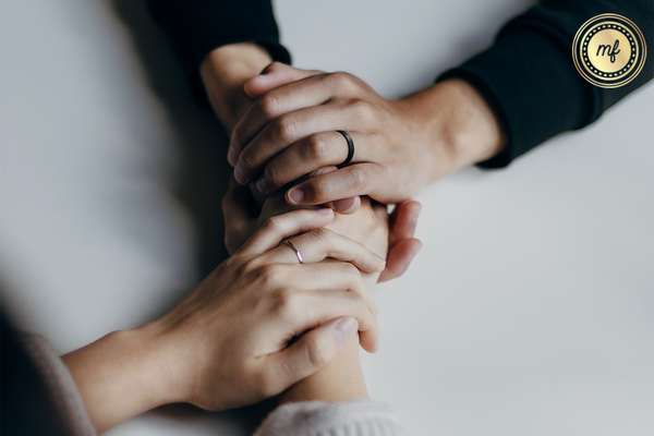 Various people holding hands.