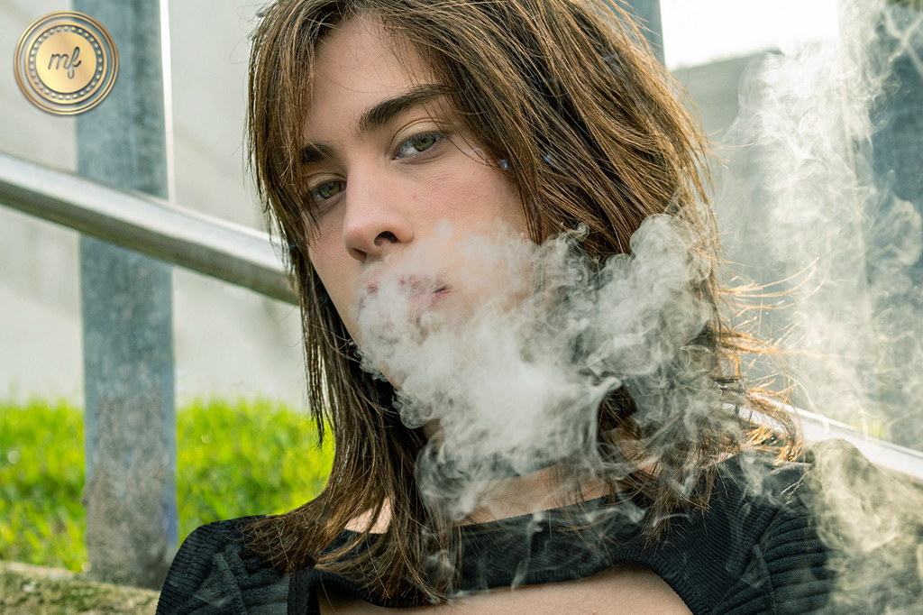 A lady enjoying and exhaling smoke