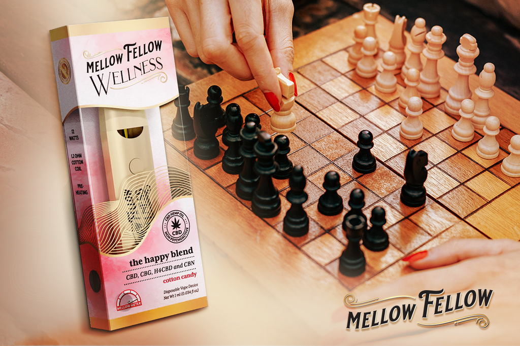 Keep a pack of Mellow Fellow vape cartridges with The Happy Blend flavor next to a lady playing chess