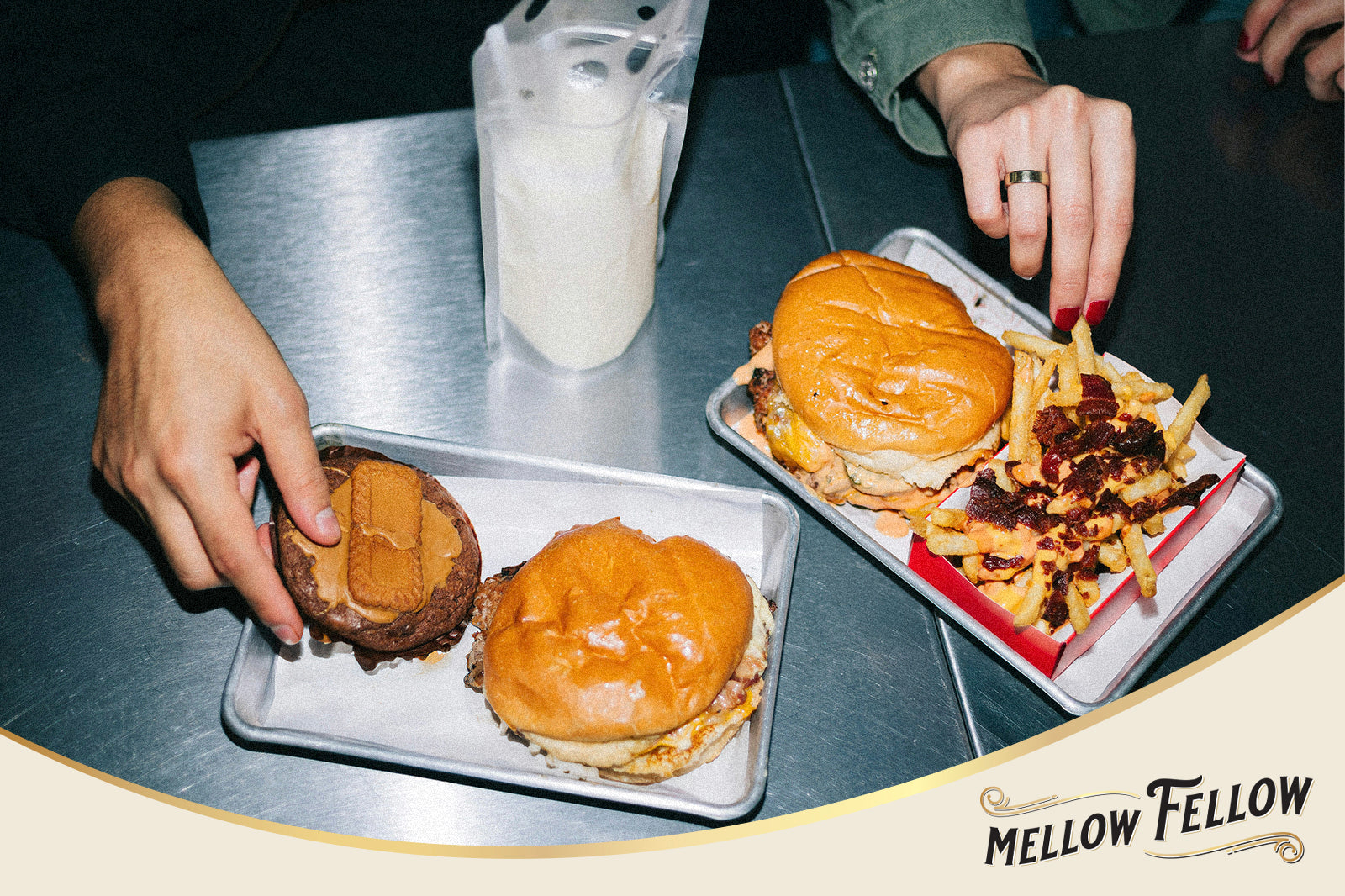 Table with burger, fries and a milkshake