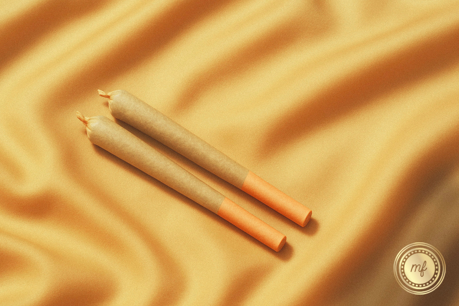 2 pre rolls on a gold surface