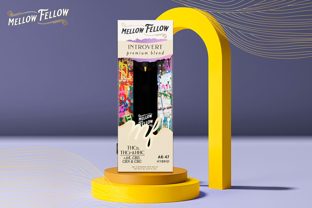 A Mellow Fellow's Introvert Premium Blend AK-47 Hybrid vape device, set against a purple background with yellow arcs