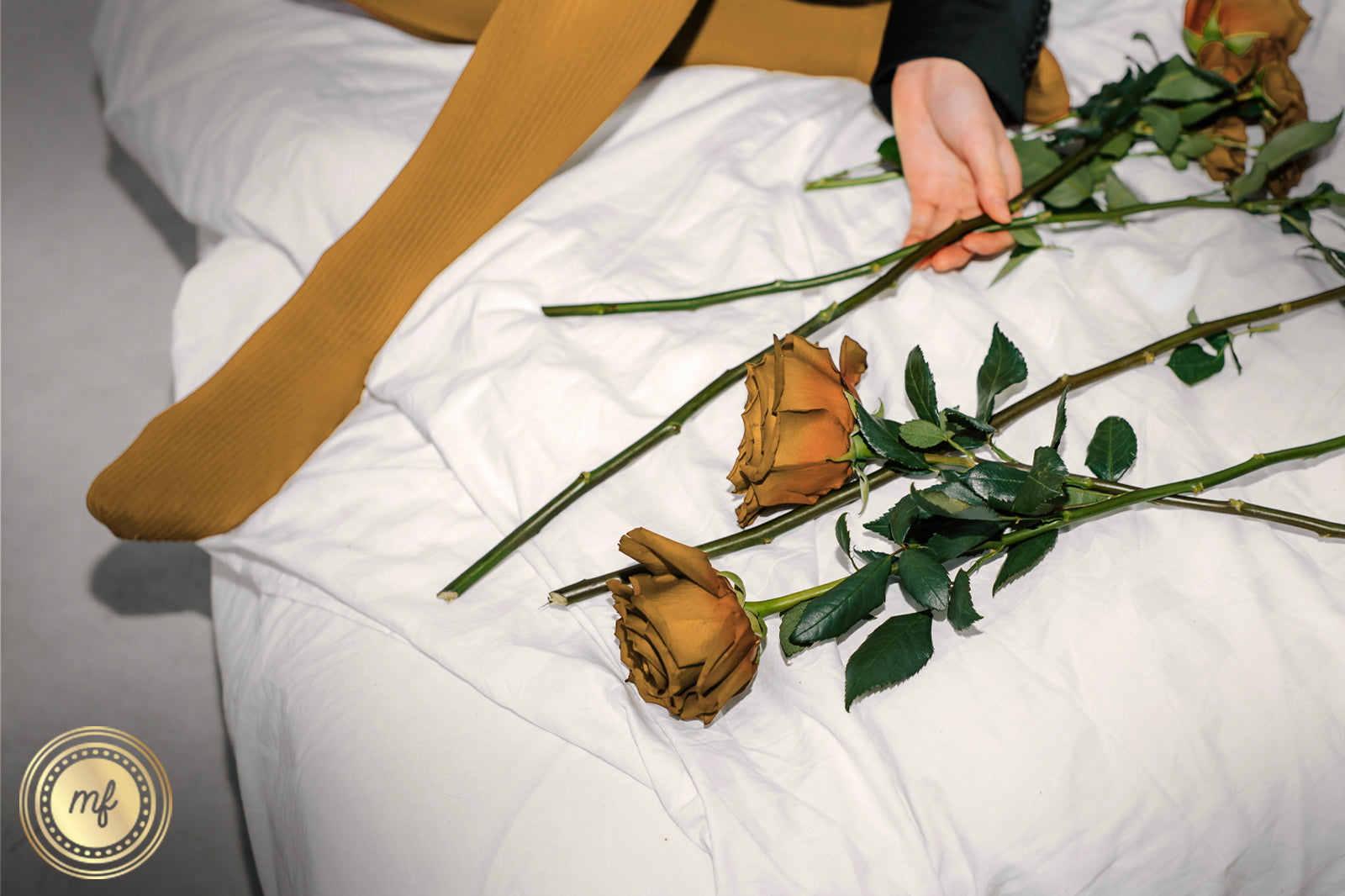 Bed with yellow roses and feet with yellow socks