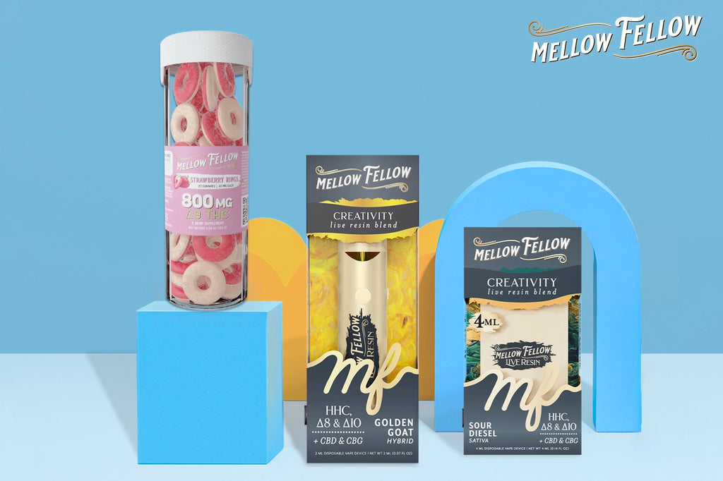 Mellow Fellow's a Strawberry Rings gummies, along with two Creativity Golden Goat and Creativity Sour Diesel vape devices, are placed against a blue background