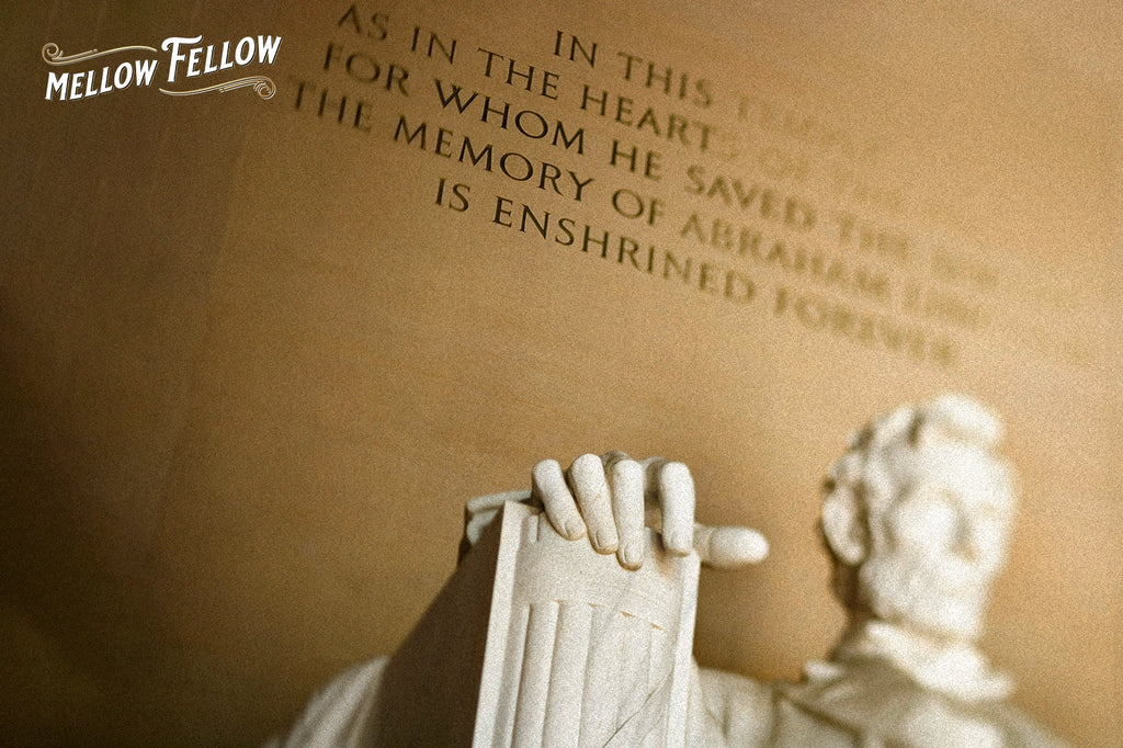 A Lincoln Memorial statue's hand and face, framed with engraved text in the background
