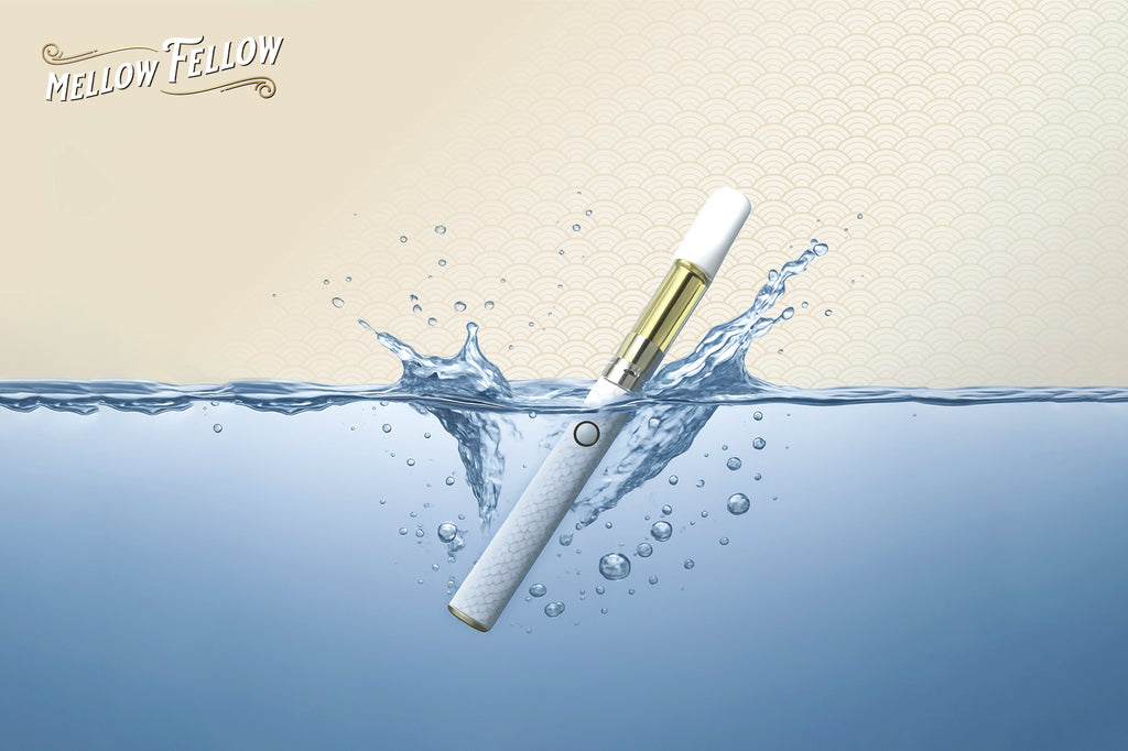 A vape pen partially submerged in water, creating splashes