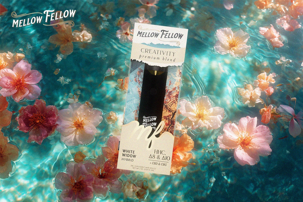 A Mellow Fellow CREATIVITY vape cartridge with White Widow flavor placed on a background of floating flowers on clear blue water