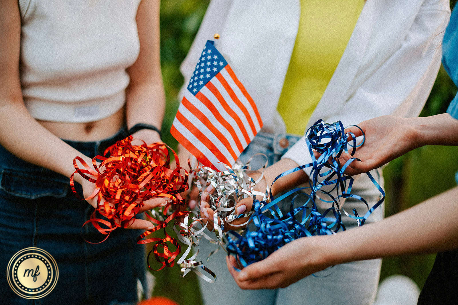 Women holding pompons and a US flag